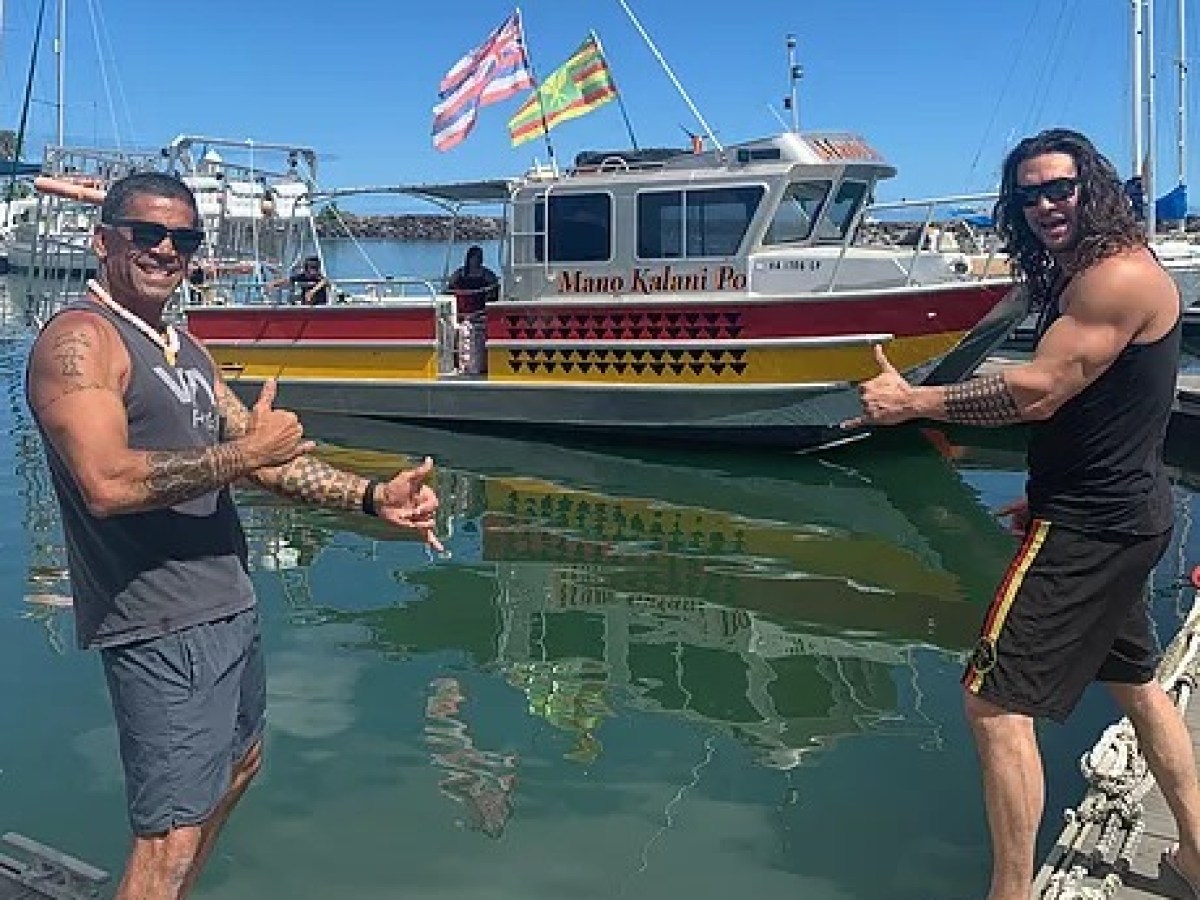 2 men in front of a boat